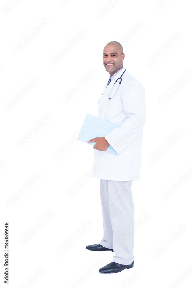 Standing doctor in white tunic writing notes Standing doctor in white tunic writing notes