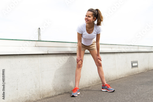 Focused runner outdoors resting with big smile