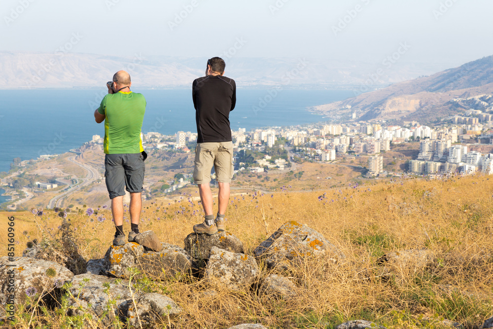 Fototapeta premium Two photographers taking picture of Tiberias sea.