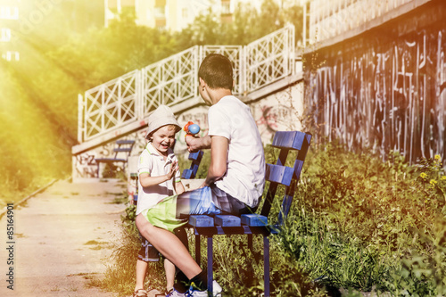 child and teenager playing in the street Water Gun