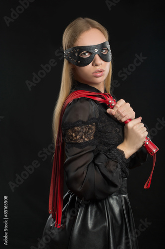 girl with red leather whip and mask BDSM