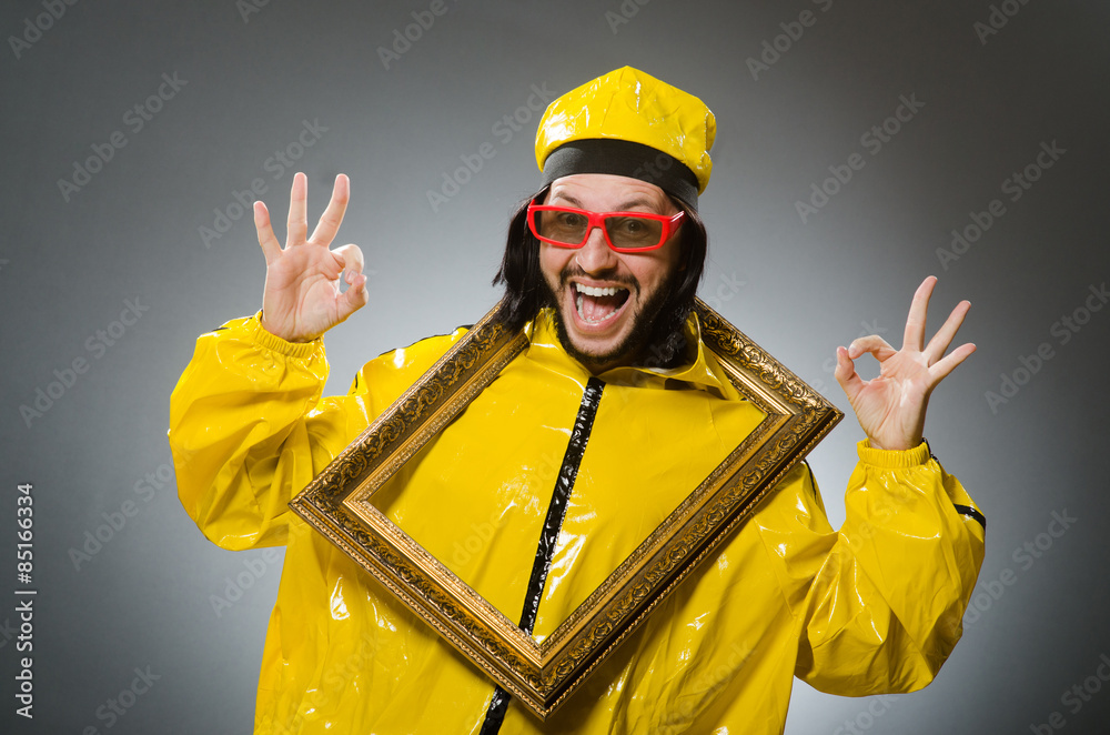 Man wearing yellow suit with picture frame Man wearing yellow suit with picture frame