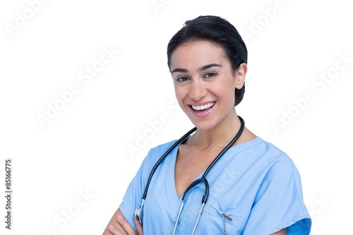 Young nurse in blue tunic with arms crossed
