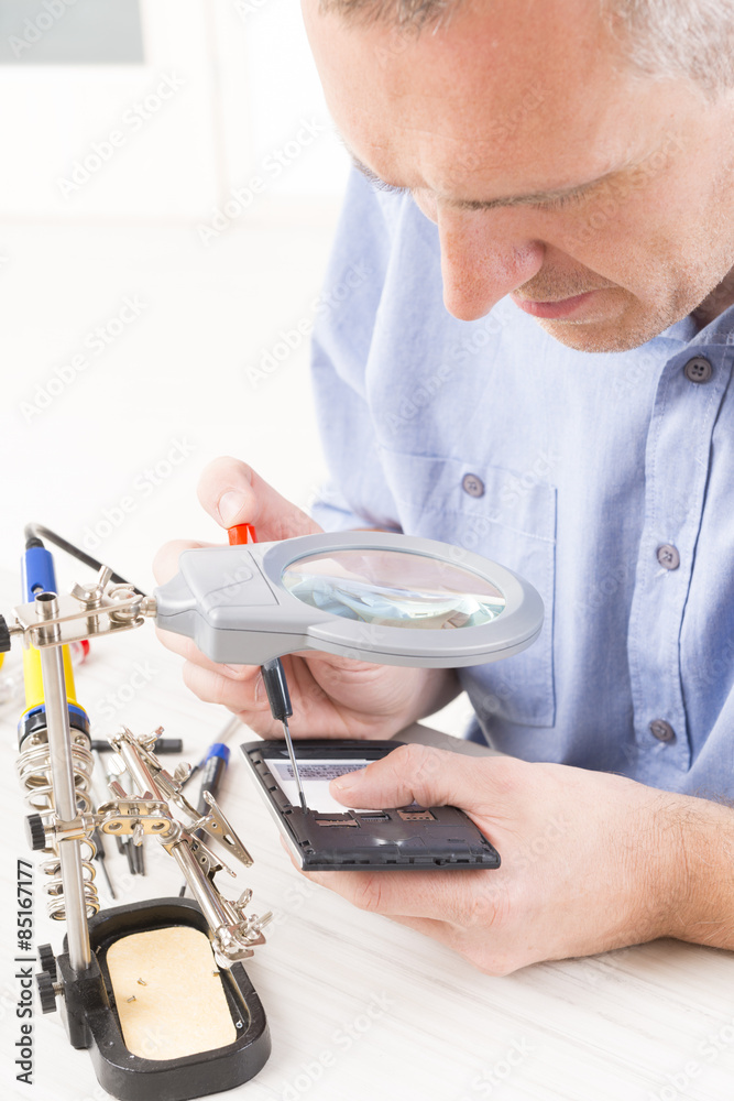 repairing mobile phone in the electronic workshop