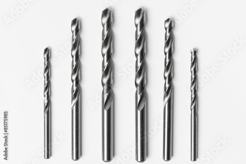 Drill bits of different sizes isolated over white background photo