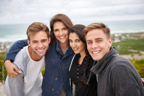 Group of friends posing for a picture together outdoors
