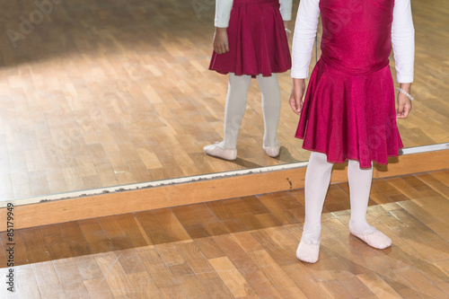 Academy for ballet preschool girl in dancing dress in front mirror