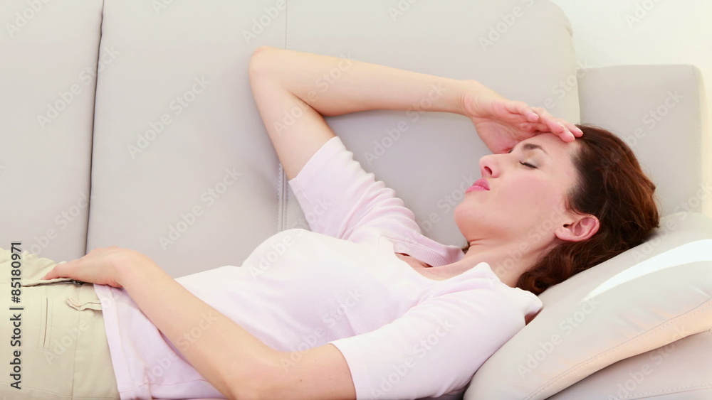Sad brunette lying on the couch Sad brunette lying on the couch