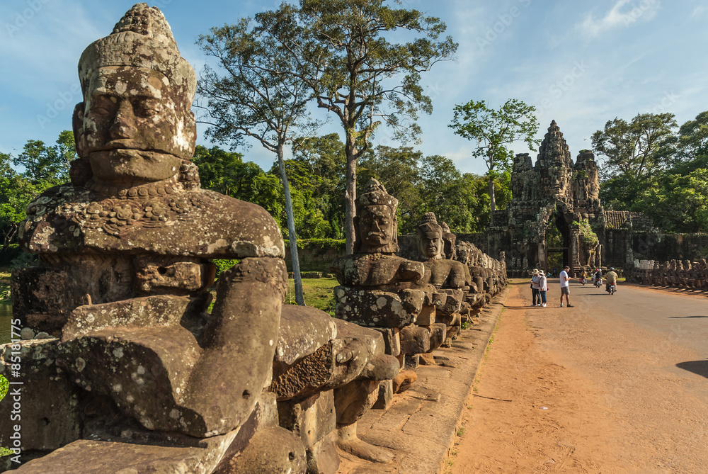 Fototapeta premium gods and demons in the access bridge to victory's gate in siam reap, cambodia