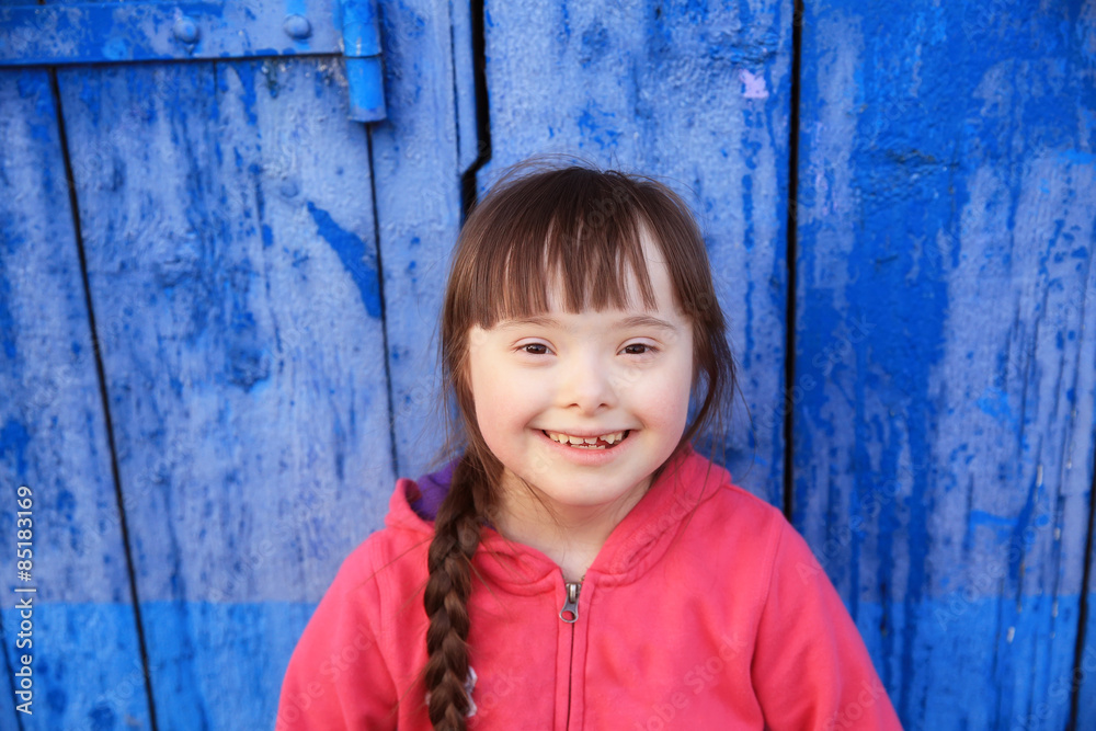 Young girl smiling on background of the blue wall. Young girl smiling on background of the blue wall.