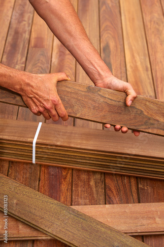 Ipe deck installation carpenter hands holding wood