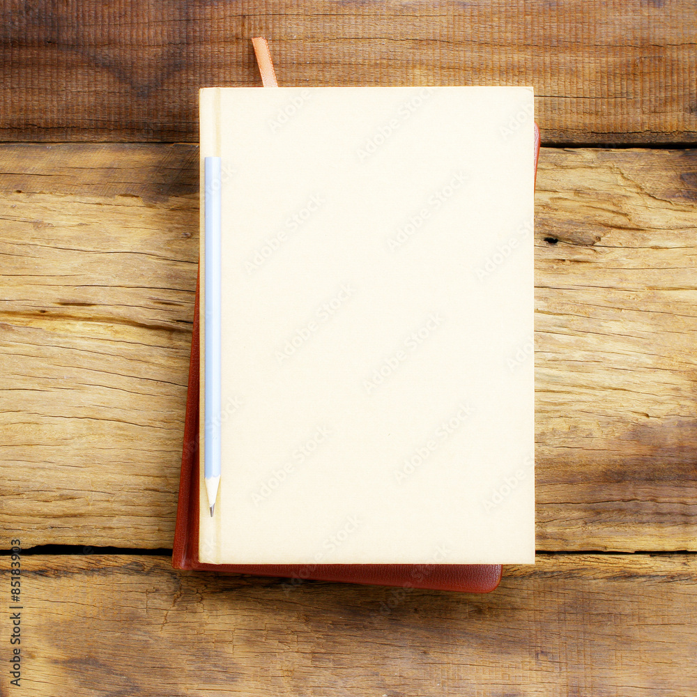 Notebook and pencil on wooden table Notebook and pencil on wooden table