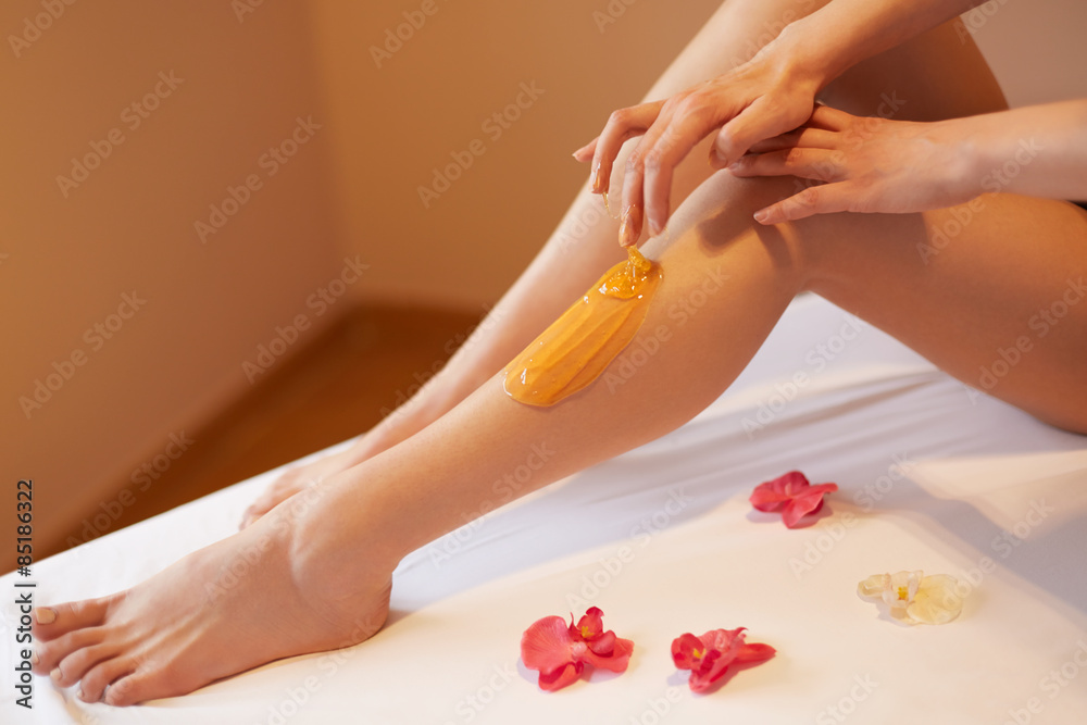 Fototapeta premium Long Woman Legs. Woman Cares About Her Legs. Sugaring Treatment
