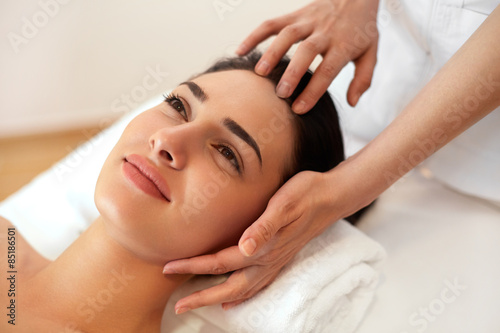 Beautiful Young Woman Getting a Face Treatment at Beauty Salon.