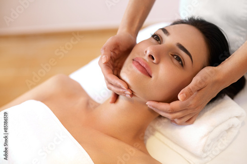 Beautiful Young Woman Getting a Face Treatment at Beauty Salon.