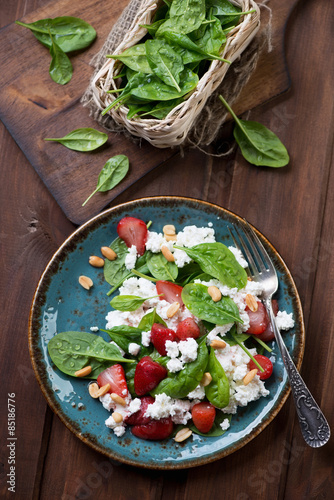 Salad with strawberries, spinach and cheese, above view