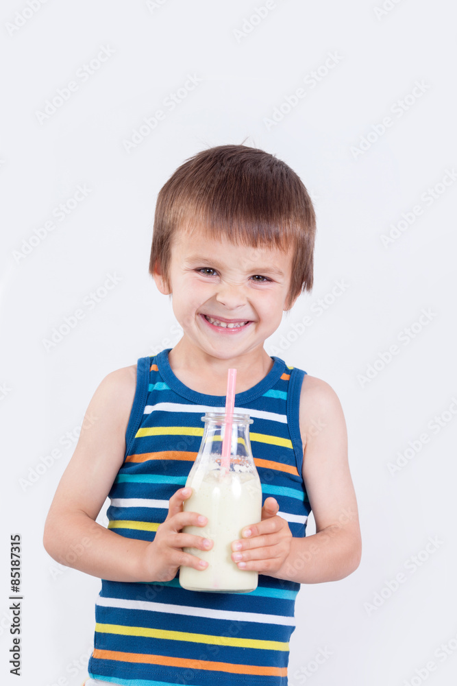 Cute little boy, drinking milk, holding glass of milk, mustaches Cute little boy, drinking milk, holding glass of milk, mustaches