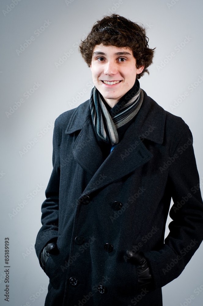 teen boy wearing a scarf and a winter pea-coat Stock Photo | Adobe Stock