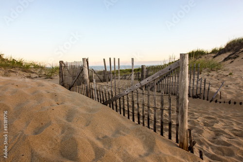 Fototapeta Naklejka Na Ścianę i Meble -  Fence with sand dunes and sky