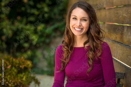 Healthy young adult woman with radiant smile and long hair