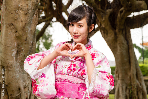 Asian woman in kimono in garden