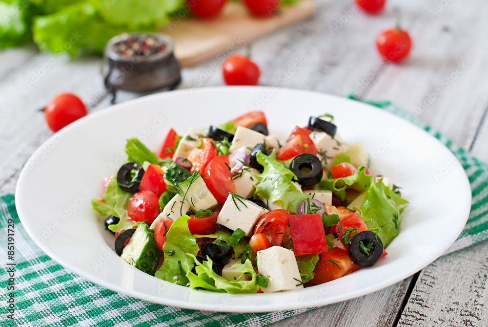 Greek salad with fresh vegetables, feta cheese and black olives Greek salad with fresh vegetables, feta cheese and black olives