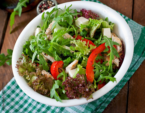 Dietary salad with chicken, cheese feta arugula and sweet red pepper