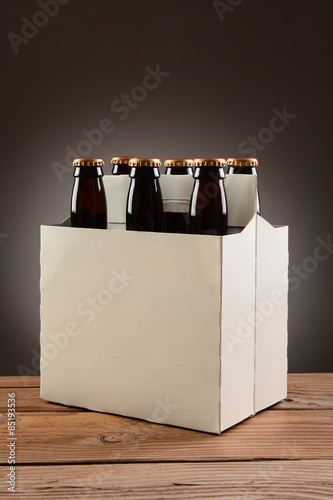 Fotografie Six Pack Beer on Wood Table