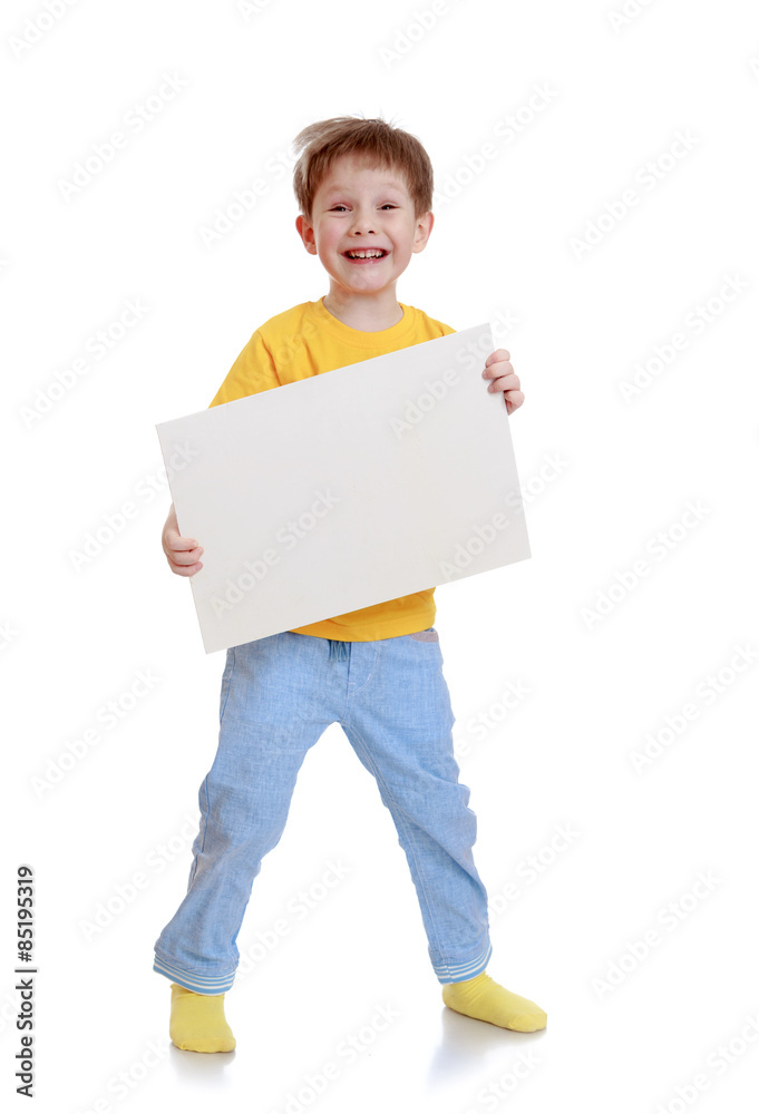 Laughing little boy is holding in front of a rectangular white p Laughing little boy is holding in front of a rectangular white p