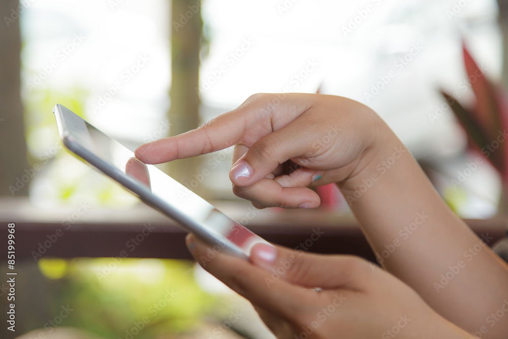 Cropped view of women using a digital tablet