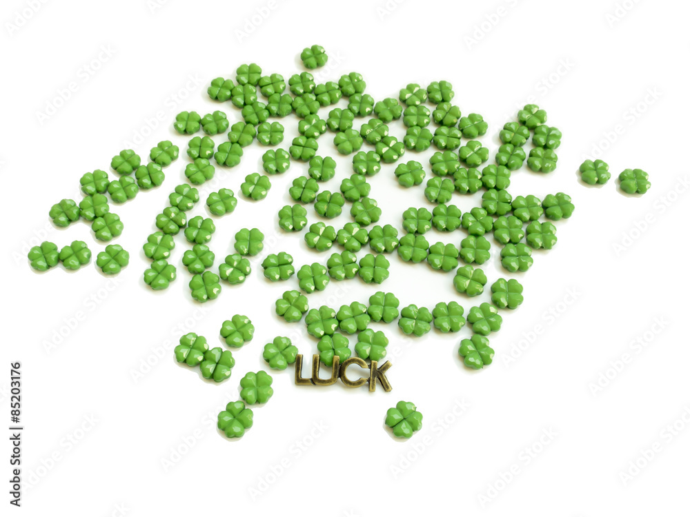 A scattering of bright shamrocks on a white background, a bronze A scattering of bright shamrocks on a white background, a bronze