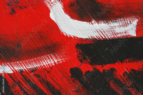 Fotografi Small part of painted metal wall with  black,red and white paint