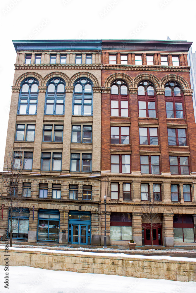 Fototapeta premium Twin Buildings - Red and White Brick Twin Buildings with Long Arched Windows
