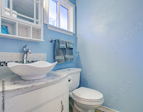 Bright bathroom with blue walls.
