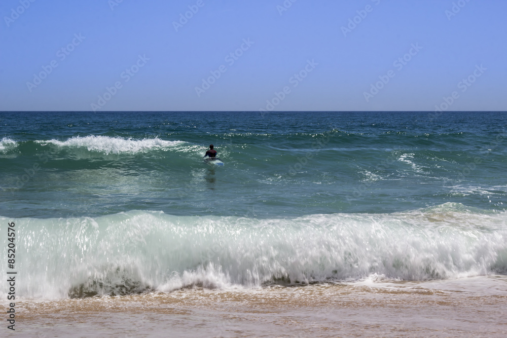 Ocean view and people surfing in Tavira Island beach, Algarve Ocean view and people surfing in Tavira Island beach, Algarve