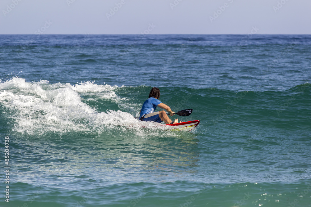 Ocean view and people surfing in Tavira Island beach, Algarve