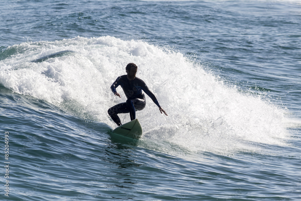 Ocean view and people surfing in Tavira Island beach, Algarve