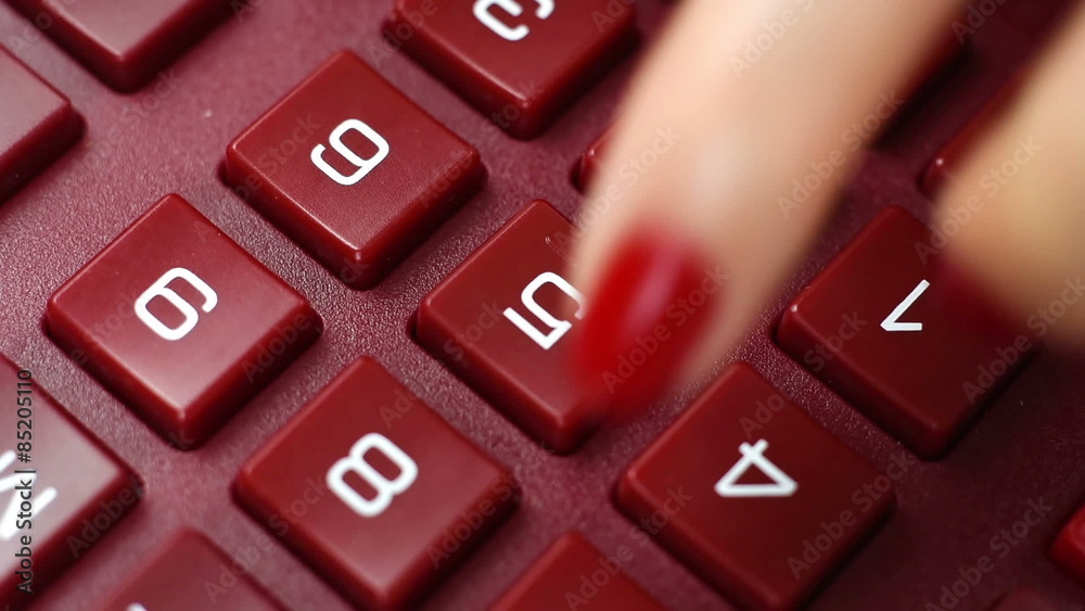 finger pushing calculator buttons, extra close up