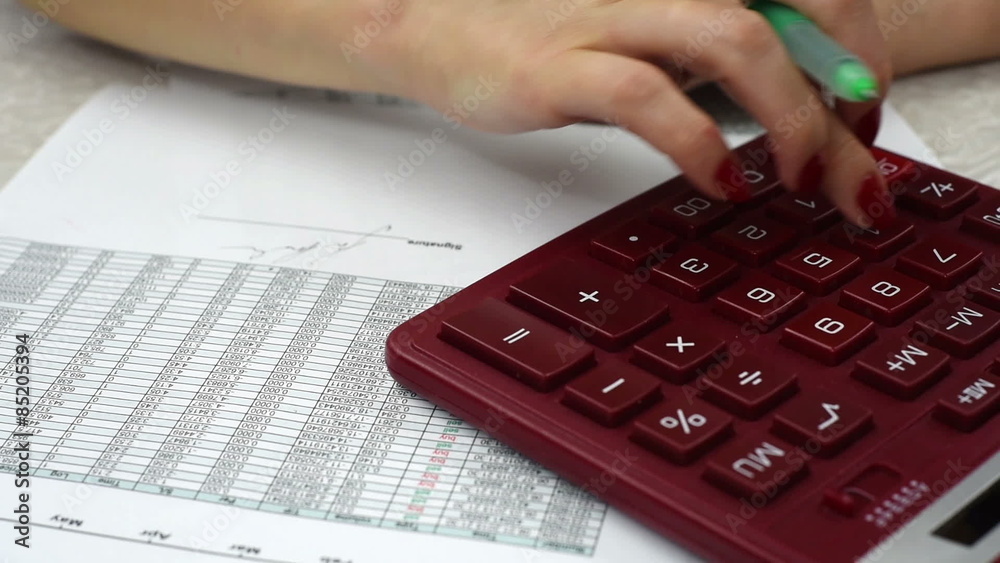 Business woman counts annual report, close up Business woman counts annual report, close up