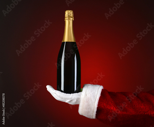 Santa Holding Champagne Bottle in Palm © Steve Cukrov