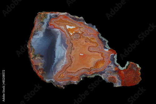 A cross section of agate stone with geode on a black background. Origin: Morocco, Asni.