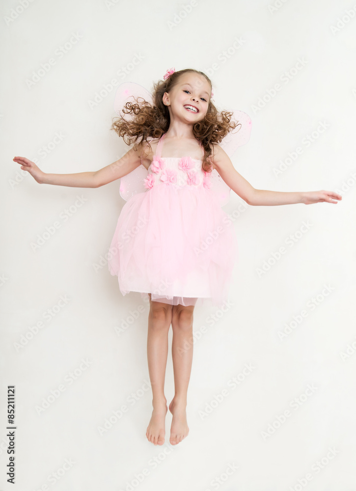 Cute girl in fairy costume posing in the studio Cute girl in fairy costume posing in the studio