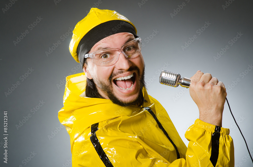 Man wearing yellow suit with mic Man wearing yellow suit with mic