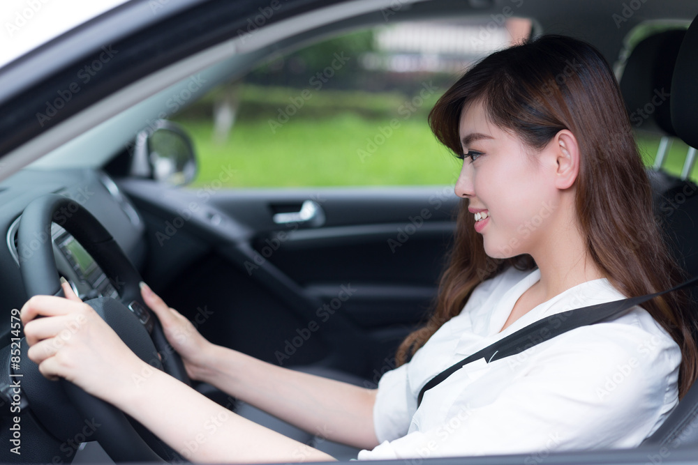Beautiful young asian woman driving car