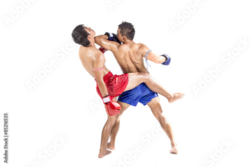 Two thai boxers exercising traditional martial art © kromkrathog