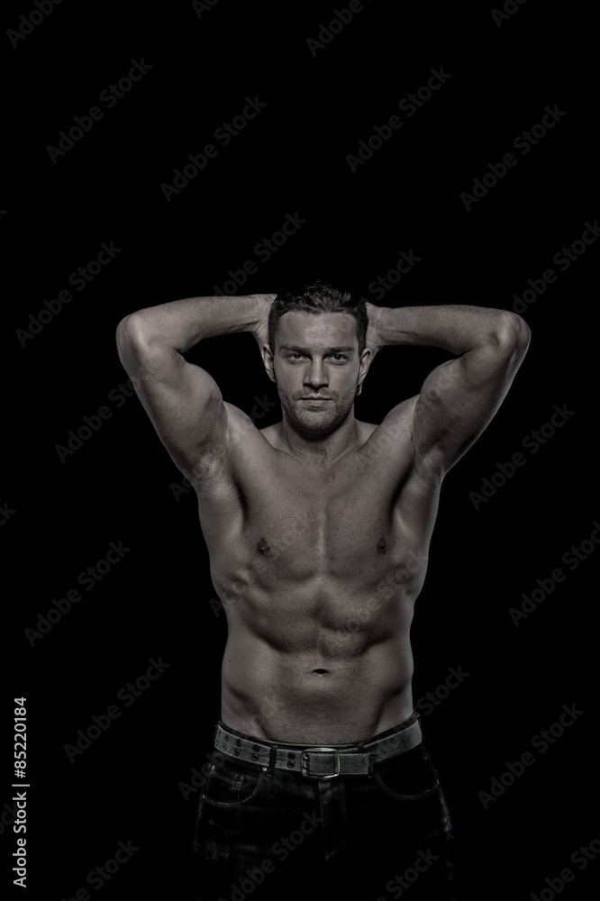 Glamour young handsome athletic man on black background Glamour young handsome athletic man on black background
