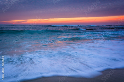 Waves in the Pacific Ocean at sunset, in La Jolla, California.