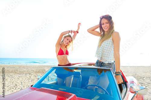 Beautiful party friend girls dancing in a car on the beach © lunamarina