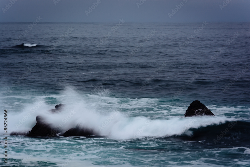 Waves and rocks in the Pacific Ocean, in Pacific Grove, Californ