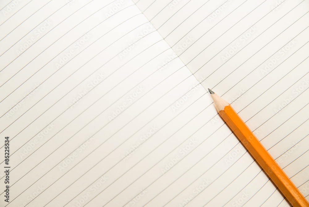 Opened notebook and pencil on the old tissue Opened notebook and pencil on the old tissue